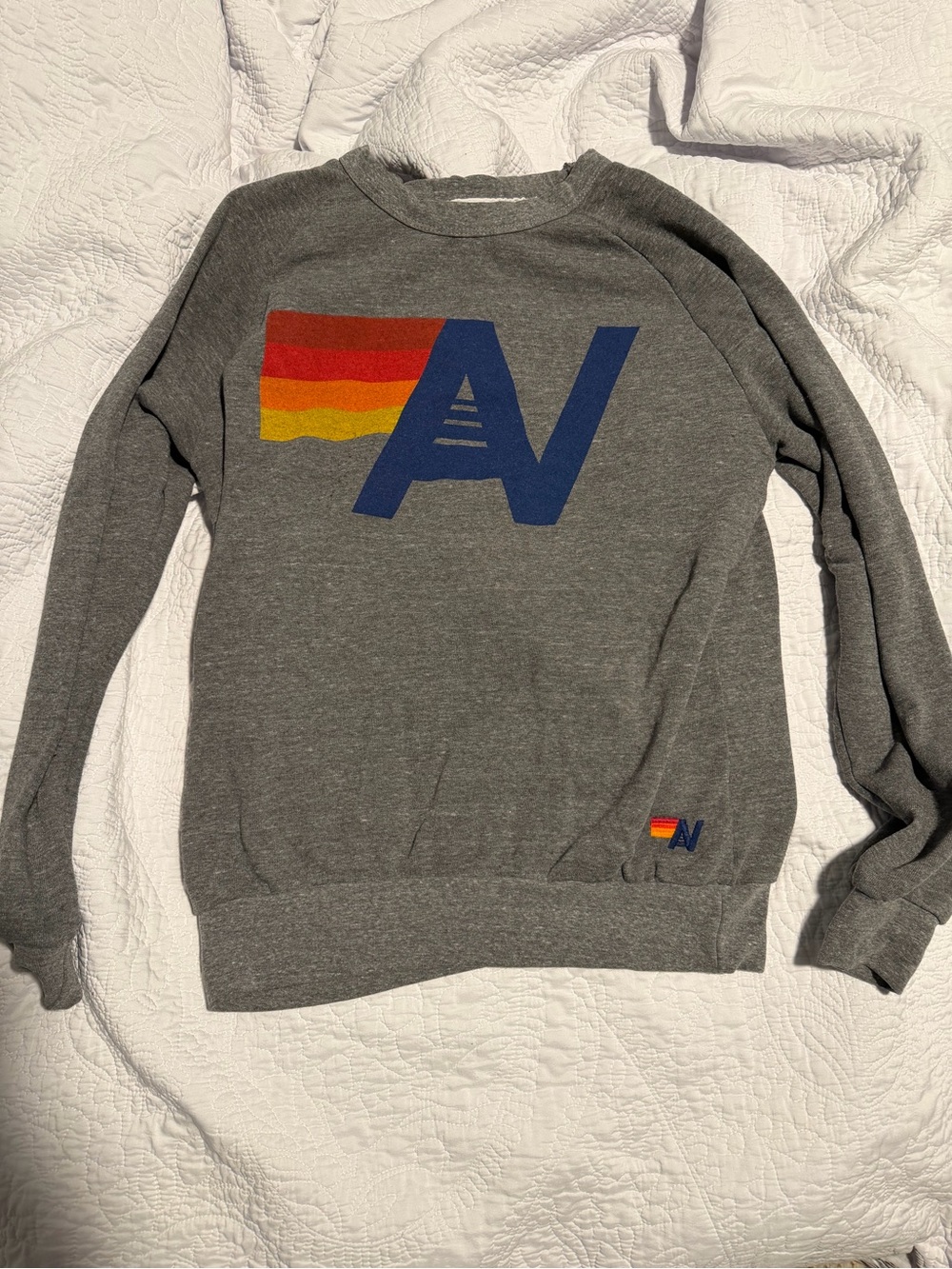 Aviator Nation Gray Sweatshirt with Blue 'AV' Logo and Red-Orange-Yellow Stripe
